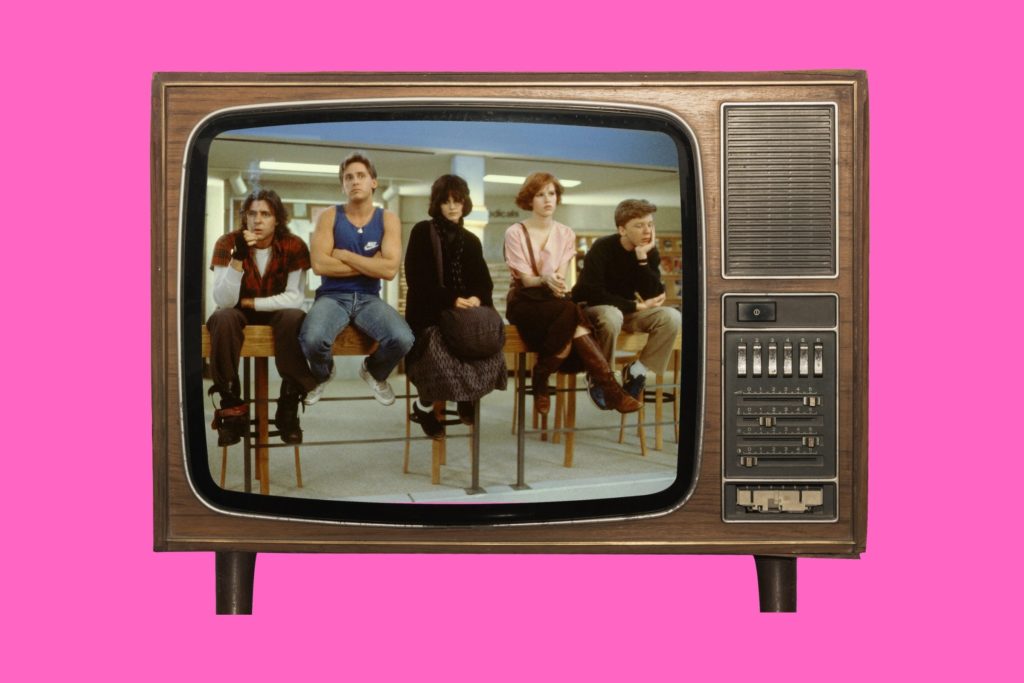 1980s Brat Pack movie posters in cinema room The Breakfast Club detention scene St Elmo’s Fire cast group image Molly Ringwald in Pretty in Pink Andrew McCarthy Brats documentary still John Hughes directing 1980s teen movie classic Brat Pack actors together 1980s teen cinema VHS collection