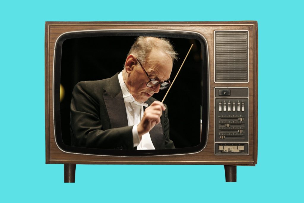 nnio Morricone conducting orchestra during film score recording Ennio Morricone composing music for Sergio Leone Westerns Clint Eastwood in The Good the Bad and the Ugly with Morricone soundtrack Ennio Morricone working inside recording studio Scene from The Mission with Ennio Morricone score Spaghetti Western soundtrack vinyl records and film posters Classic Ennio Morricone soundtrack collection on shelf Five Minute Film School Ennio Morricone episode thumbnail
